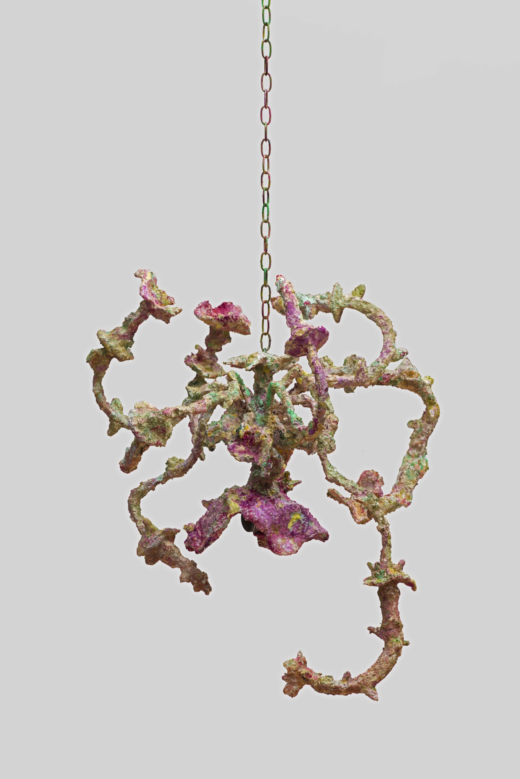 a hanging sculpture with pink flowers of genitalia
