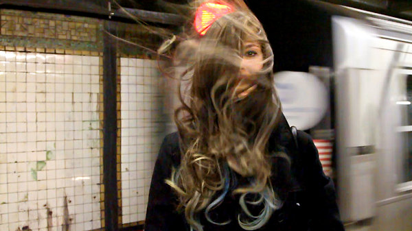 Neil Goldberg's video “Wind Tunnel” shows subway riders being hit with a blast of air from approaching trains. Courtesy of the artist 